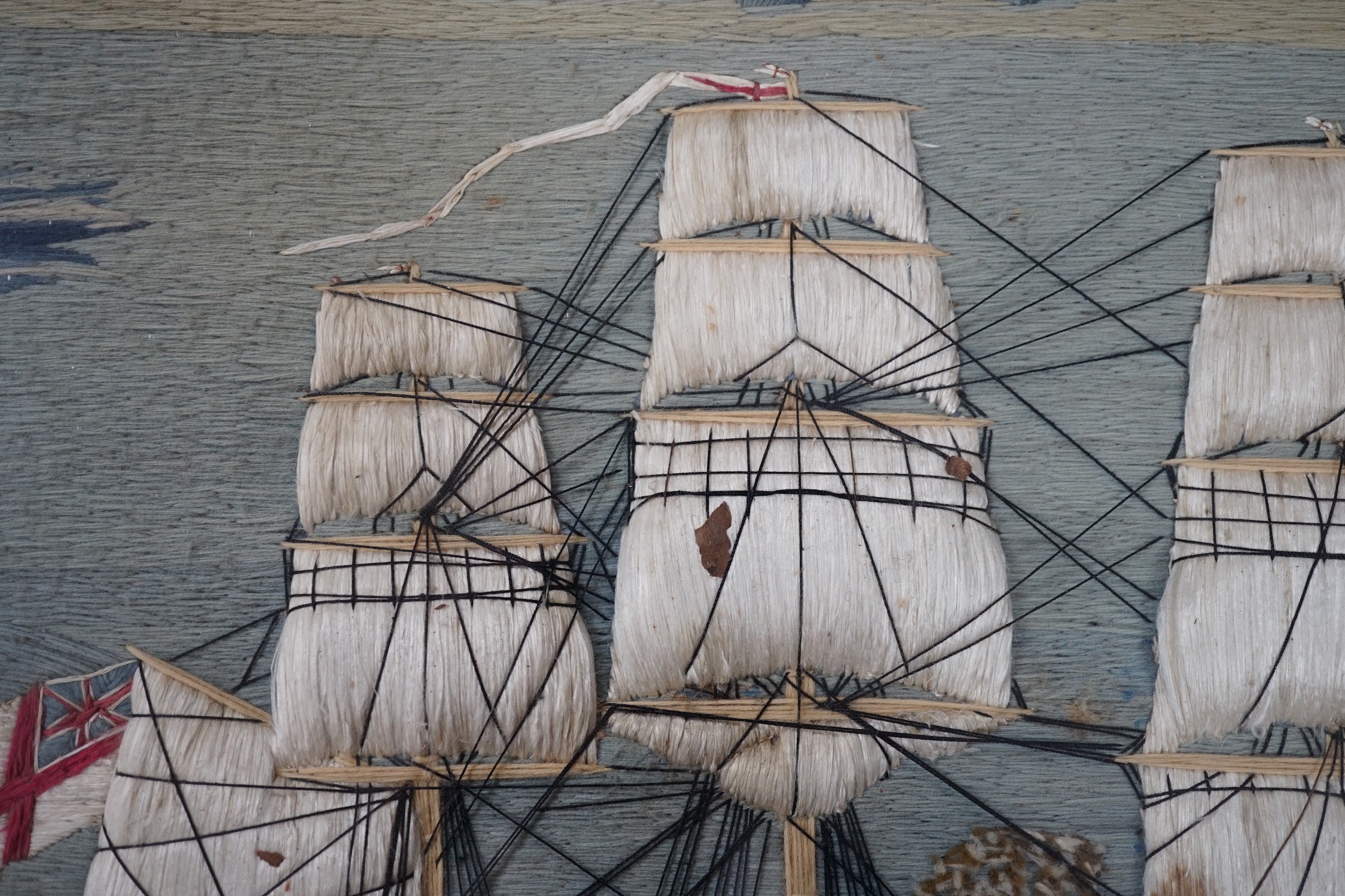 A maple framed 19th century wool work embroidery of a steam ship of the English fleet, 63cms wide, 47cms high